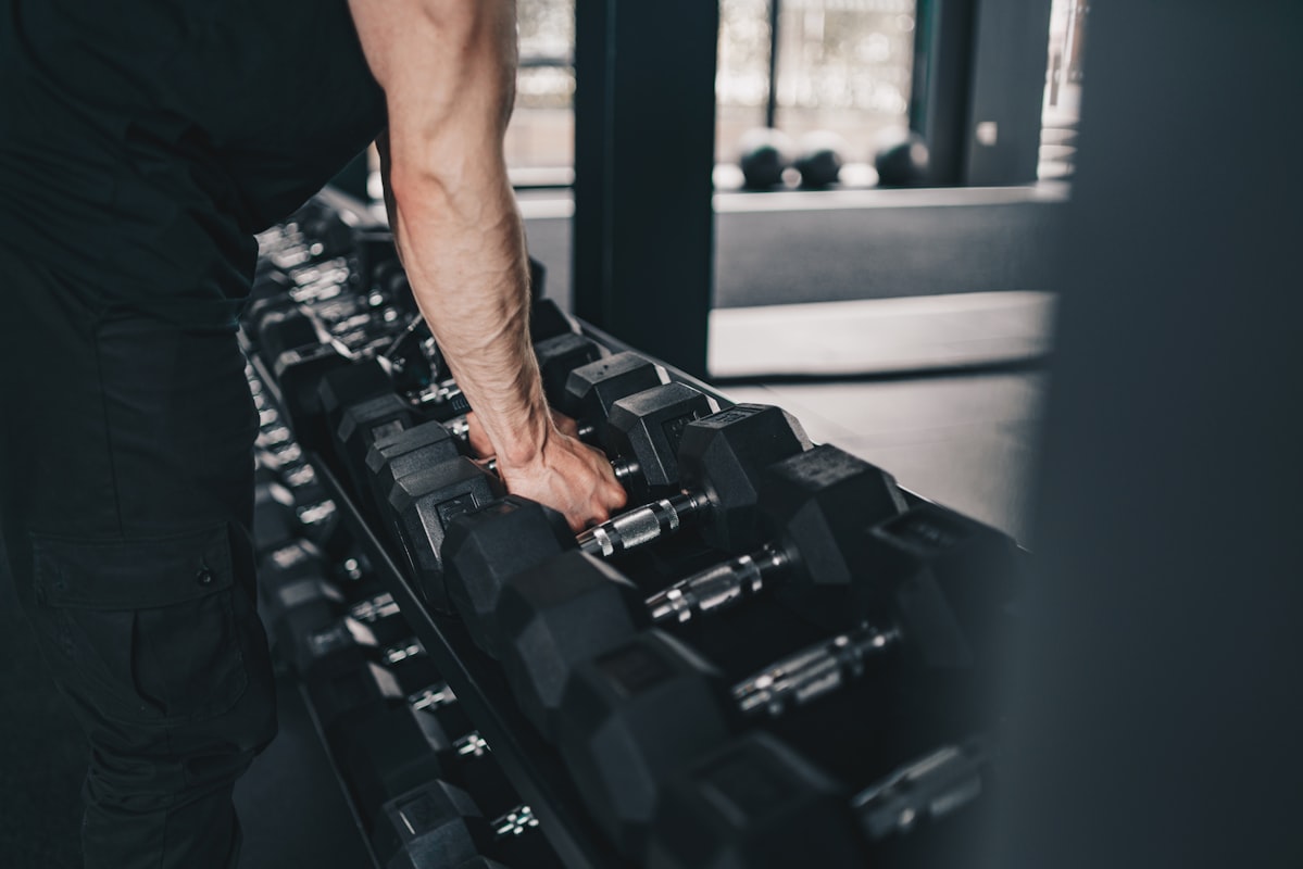 Man performing barbell squats in gym